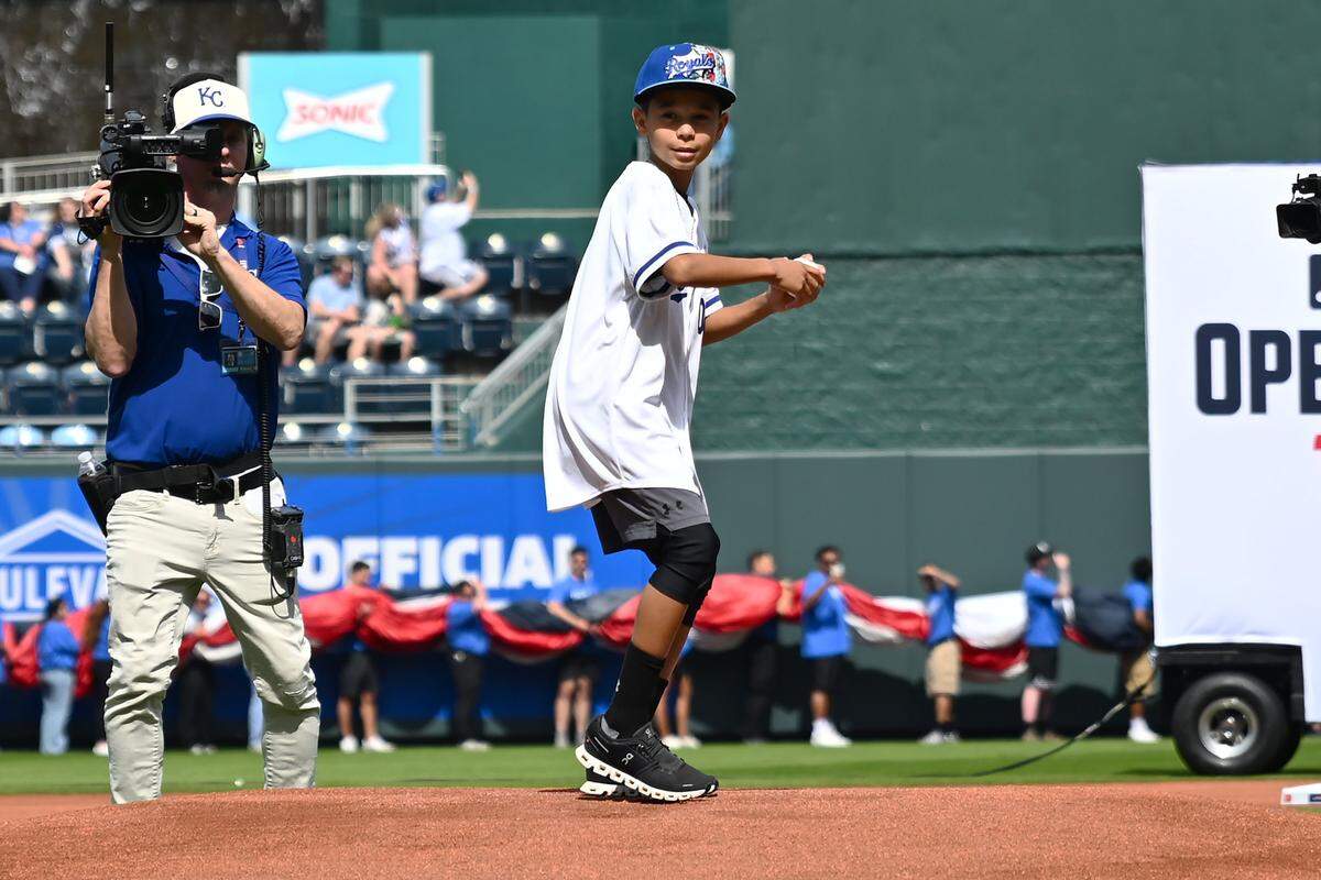 Zane Gore, son of Terrance Gore, throws out the first pitch before the Kansas City Royals take on the Minnesota Twins during the home opening game at Kauffman Stadium on Monday, March 30, 2026, in Kansas City.