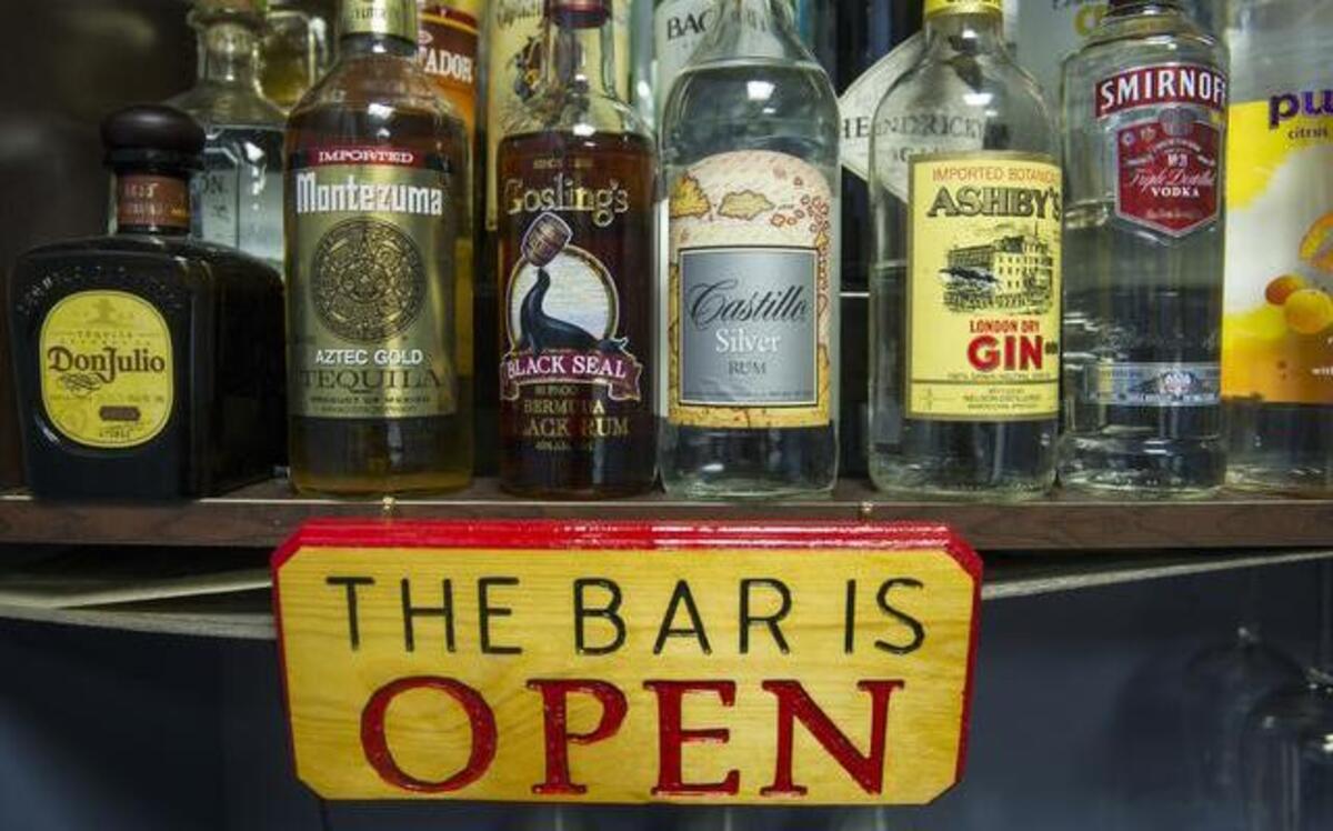
Alcohol bottles, their contents replaced with colored water, sit on a shelf in the National Institute on Alcohol Abuse and Alcoholism’s research alcohol bar at National Institutes of Heath in Bethesda, Md. 
