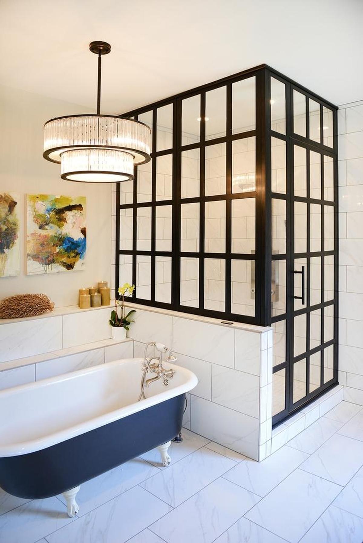 A black clawfoot tub and a walk-in shower surrounded by a paned glass wall and door add to the European feel of the master bathroom.