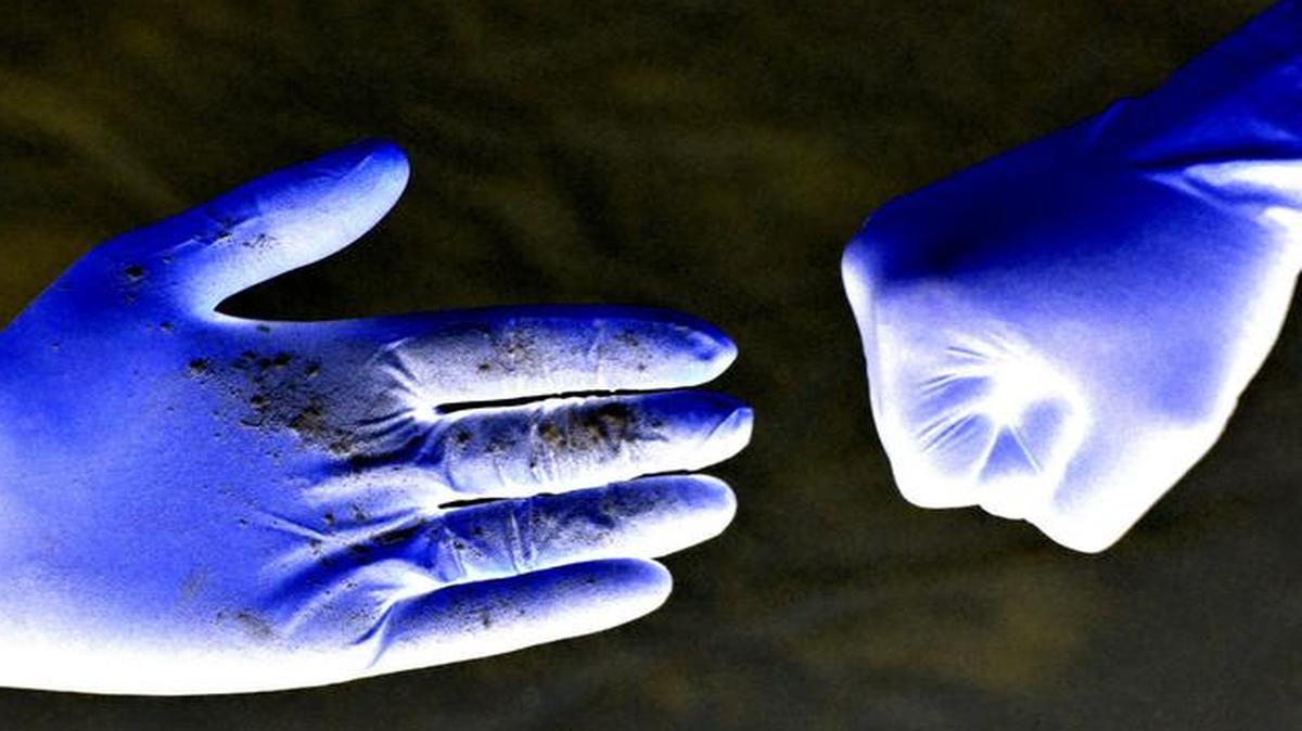 
This inverted image shows powder transferred following a handshake to illustrate possible transfer of bacteria 
