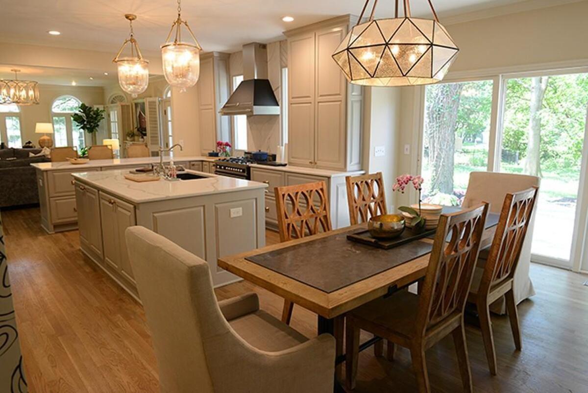 The dining room sits on one end of the kitchen near a fireplace. The living room is on the other side of the kitchen.