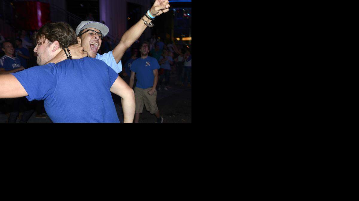 
Fans celebrate as the Kansas City Royals win their Wild Card Gamne over the Oakland A's Tuesday night at the Power and Light District.
