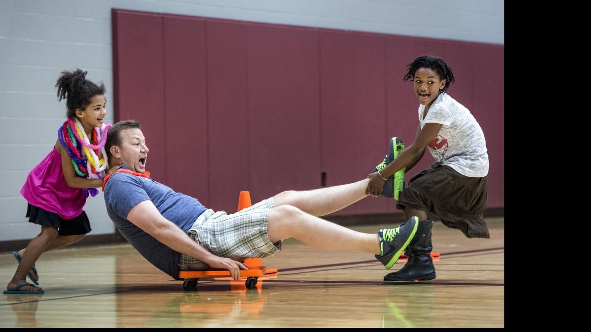 
Another kind of respite night, this time for siblings of special needs kids, is held at Redeemer Presbyterian Church. That’s where 7-year-old Jeiyona Hammond (left) and 10-year-old Jasziel Potts provided the propulsion for volunteer Fred Wingert during a scooter race.
