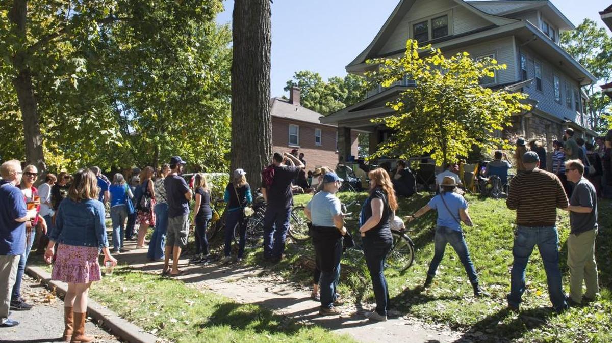 A crowd gathered near a house on W. 38th Street to listen to music at a PorchFest in a previous year. The event comes back Oct. 12.