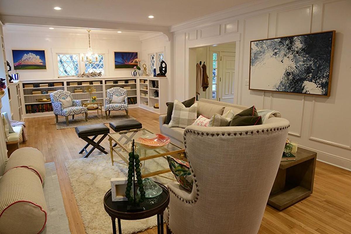 Tamara Day and the “Bargain Mansions” crew trimmed out and painted the living room walls to look paneled.