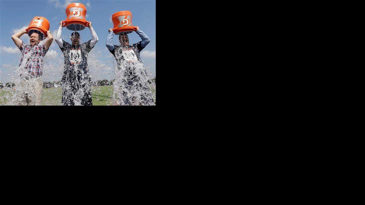 
Houston Chronicle reporter Brian Smith (from leeft) Houston Texans coach Bill O’Brien and Chief Operating Officer Cal McNair pour ice water over their head after an NFL football training camp practice last week as part of the ALS Ice Bucket Challenge to raise money for the ALS Association. 
