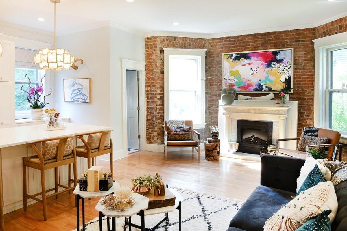 Day removed a wall in the living room that has an exposed brick wall so it opens onto the kitchen.