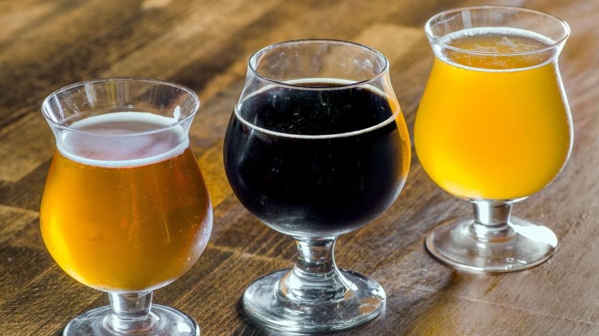 Craft breweries are proliferating in Kansas City, offering their own variations on classic styles of beer. Examples: (From left) Torn Label Brewing Co.’s Monk and Honey beer, Border Brewing Co.’s Campfire porter and Double Shift Brewing Co.’s Hayloft Saison.