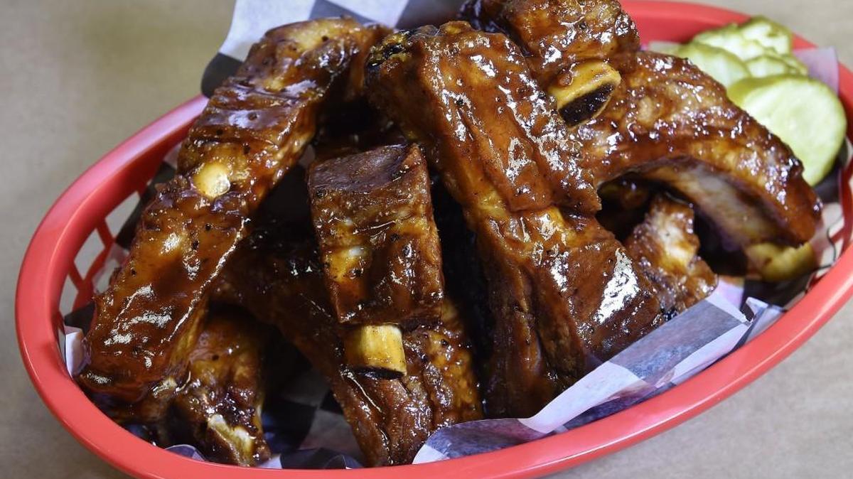 Baby Back Rib Basket: Piled high and tossed in competition-style glaze with pickles on the side.