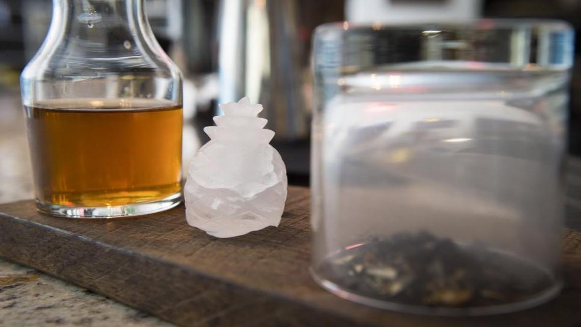 The Smoky Cocktail features a combination of pineapple rum, ginger and chile liqueurs and coffee bitters. Guests pour the concoction over a pineapple-shaped ice cube into a smoke-infused glass.