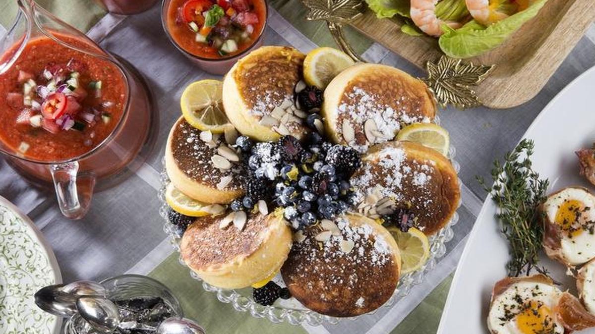 An easy-to-do spring brunch spread includes Cheese Grits, Watermelon Gazpacho, Japanese-Style Lemon Ricotta Hotcakes With Berries, Shrimp Caesar With Parmesan Crisps and Baked Egg and Prosciutto Baskets.