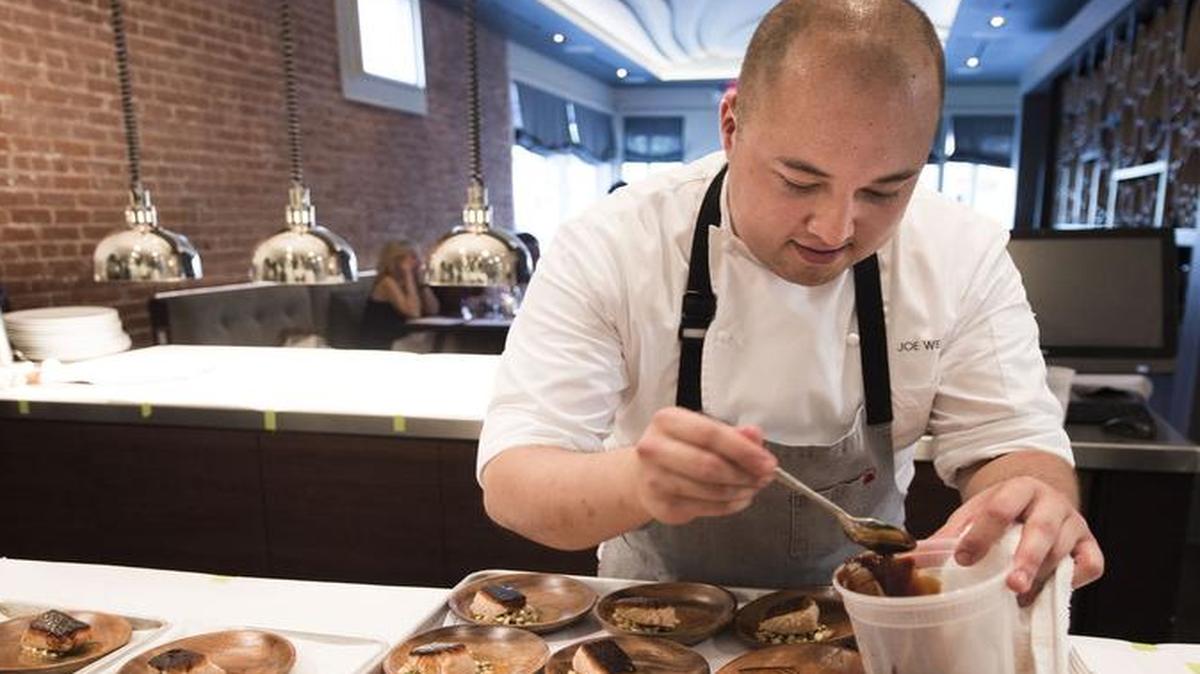 
Joe West adds Japanese kabayaki sauce to a salmon dish during a pop-up event at Bluestem in Westport.
