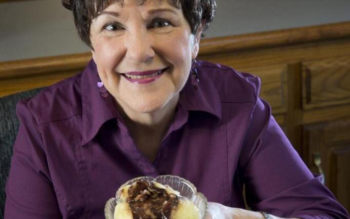 Community volunteer Susie Klinock adds a sweet end to the Passover feast
