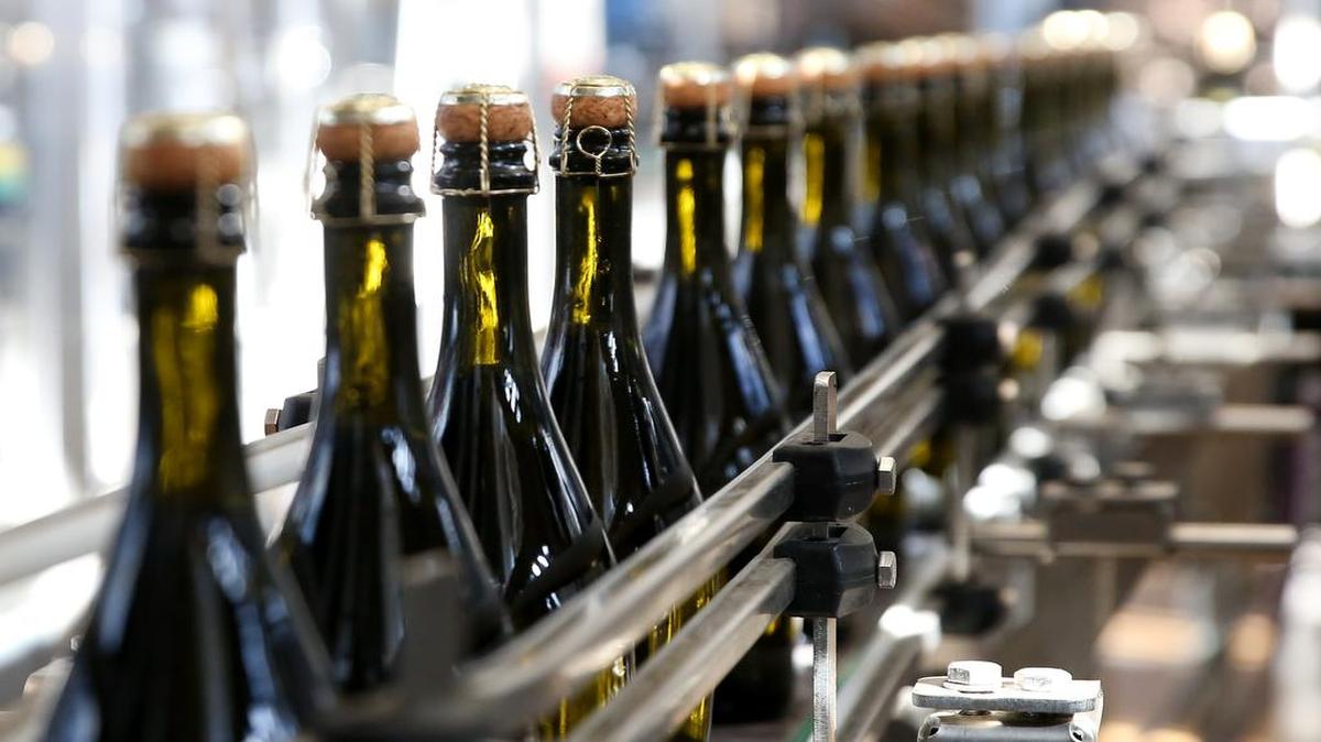 Bottles of Italian Prosecco wine moved along a conveyor belt at a winery in Conegliano, Italy.