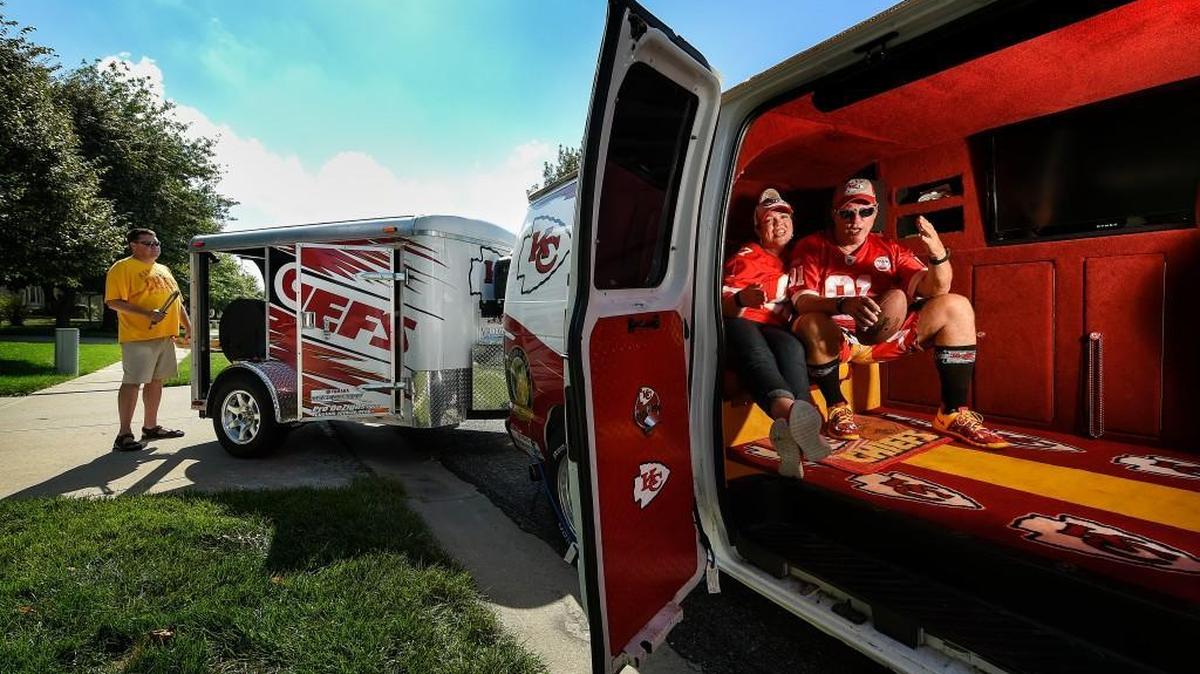 
Meet the “Arrowhead Assault Vehicle,” a highly customized van featuring twin televisions, a giant cooler and a smoker towed on a detached trailer. Expect to see it at Thursday’s game at Arrowhead Stadium, in Lot H. Lynda Brown and David Poort, both from the Lake of the Ozarks, will be there; at left is Bret Regnary.


