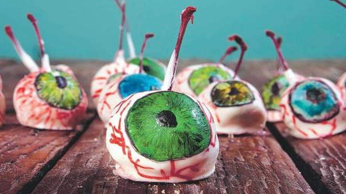 
 J.C. Gregg of Kansas City fashions maraschino cherries into eyeballs by covering them in fondant, dipping them in white chocolate and decorating.
