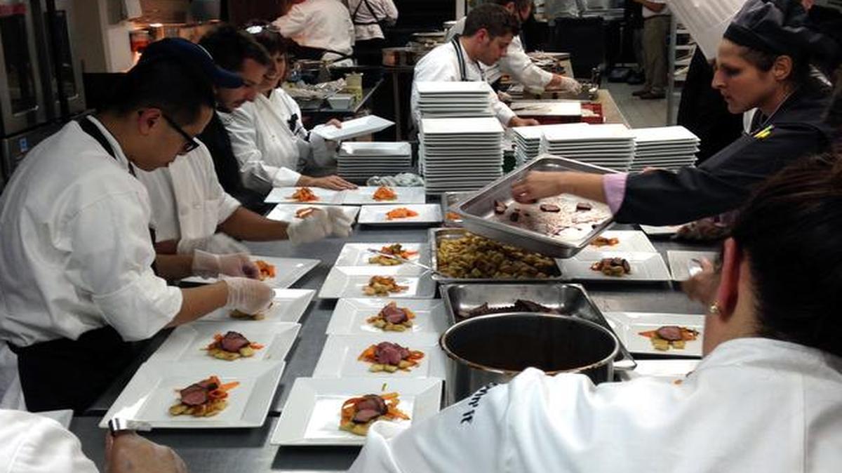 
Staff members prepare dishes of slow-cooked beef served with gnocchi fashioned out of McDonald’s french fries and a fruit sauce from its smoothie mix
