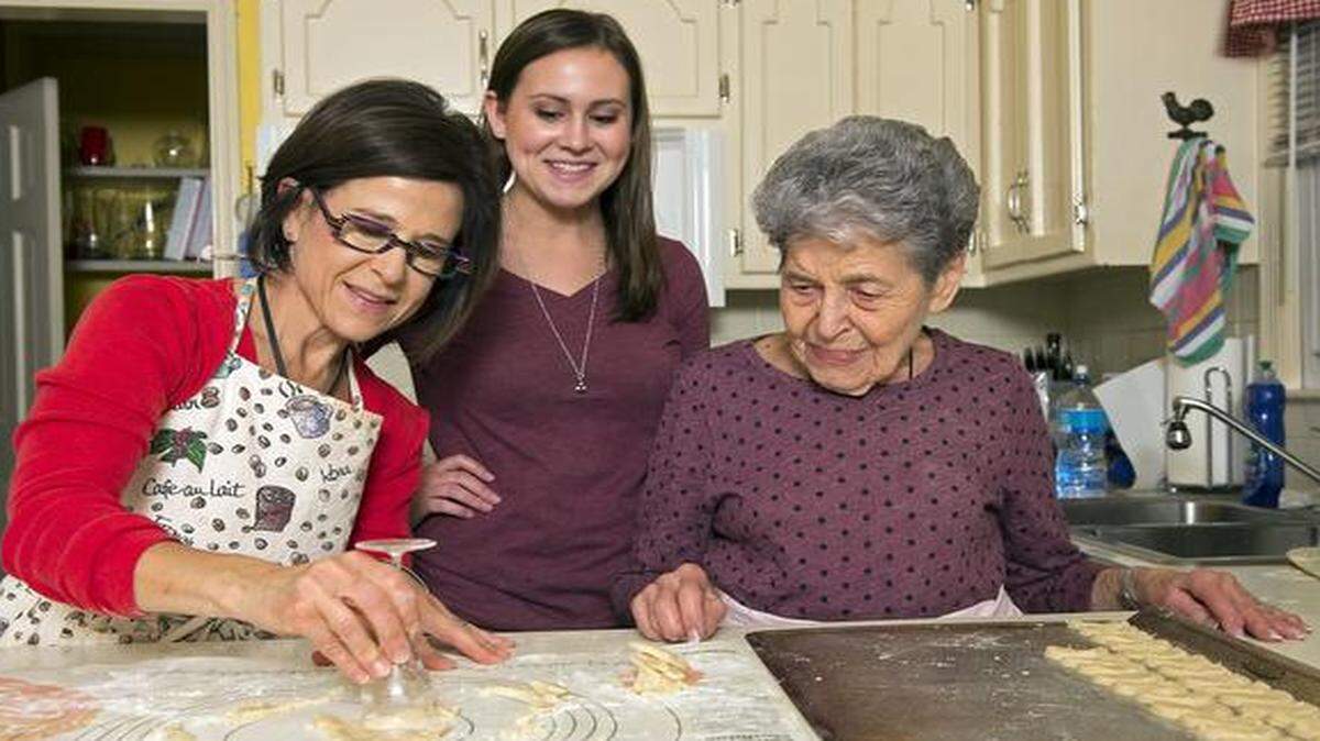 
Barb Kovacs, (from left), her daughter, Emily Kovacs, and her mother, Joan Mindlin, gathered at Barb’s home in Overland Park, to make the foods that are part of their traditional Hanukkah celebration. The women used an antique wine glass as a cookie cutter to cut out the dozens of kiflins, a traditional cookie enjoyed by their family during Hanukkah.
