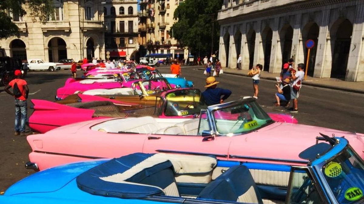 Classic cars painted all sorts of vibrant colors attract plenty of attention from Americans in Havana.