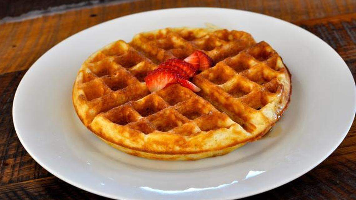 
The Waffle Iron, a pop-up waffle shop inside Lawrence’s Decade coffee shop, serves three types of waffles: Buttermilk, gluten-free and leavened (shown here with vanilla bean maple syrup and strawberries). 
