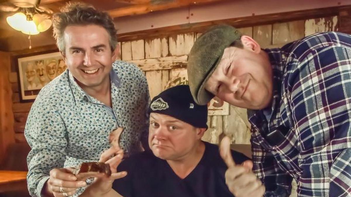 Richard Coates (far left), executive chef for London-based Bodean’s barbecue, Andre Blais, owner, and Quentin Reynolds, chief designer, sampled the flavors of Woodyard’s Bar-B-Cue.