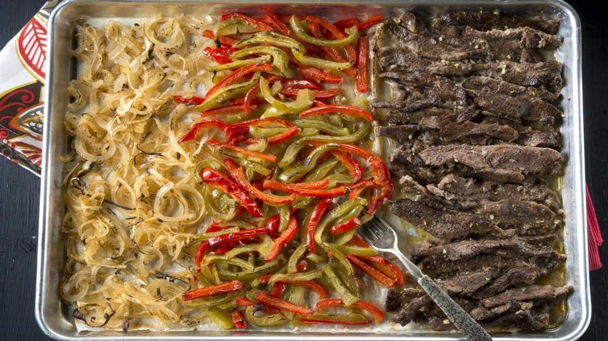 Sheet pan suppers, like beef fajitas, allow the cook to roast all ingredients in a single dish for easy cooking and clean up.