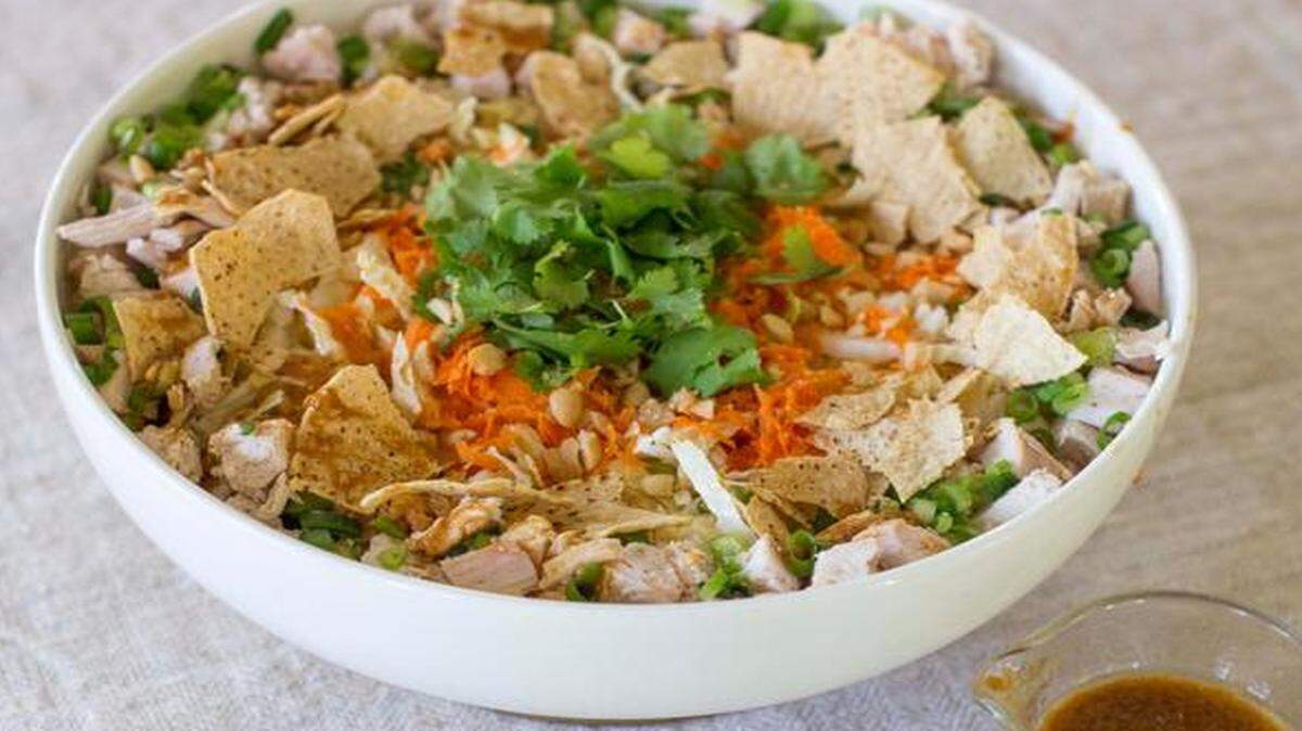 Turkey goes from the star of the Thanksgiving feast to a co-star in a healthful dinner in Turkey and Napa Cabbage Salad With Lime-Ginger Vinaigrette.<252><137>This Oct. 27, 2014 photo shows turkey with Napa cabbage salad with lime ginger vinaigrette in Concord, N.H. It is easy to turn leftover Thanksgiving turkey into a dinner-worthy salad that will have everyone craving more greens. (AP Photo/Matthew Mead)<252><137>