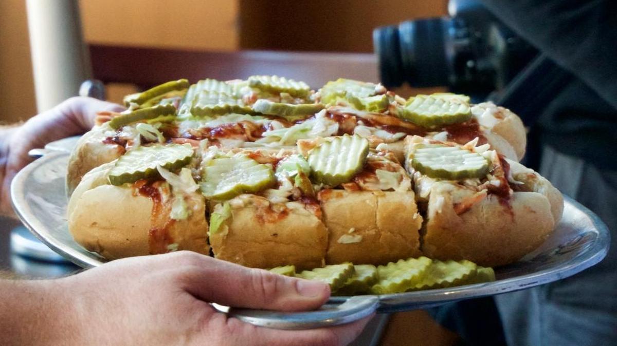Plowboys Barbeque in downtown Kansas City recently rolled out a sandwich inspired by the new streetcars. The Streetcar Sandwich features a Roma hoagie bun loaded with pulled pork, ham and sausage. The sandwich is topped with creamy coleslaw, pickles and Plowboys’ KC Crossroads sauce.