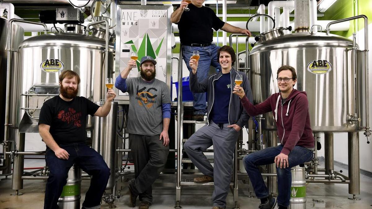 Crane Brewing’s Randy Strange (from left), Aaron Bryant, Michael Crane, Chris Meyers and Steve Hood raise a glass to their fledgling Raytown brewery.