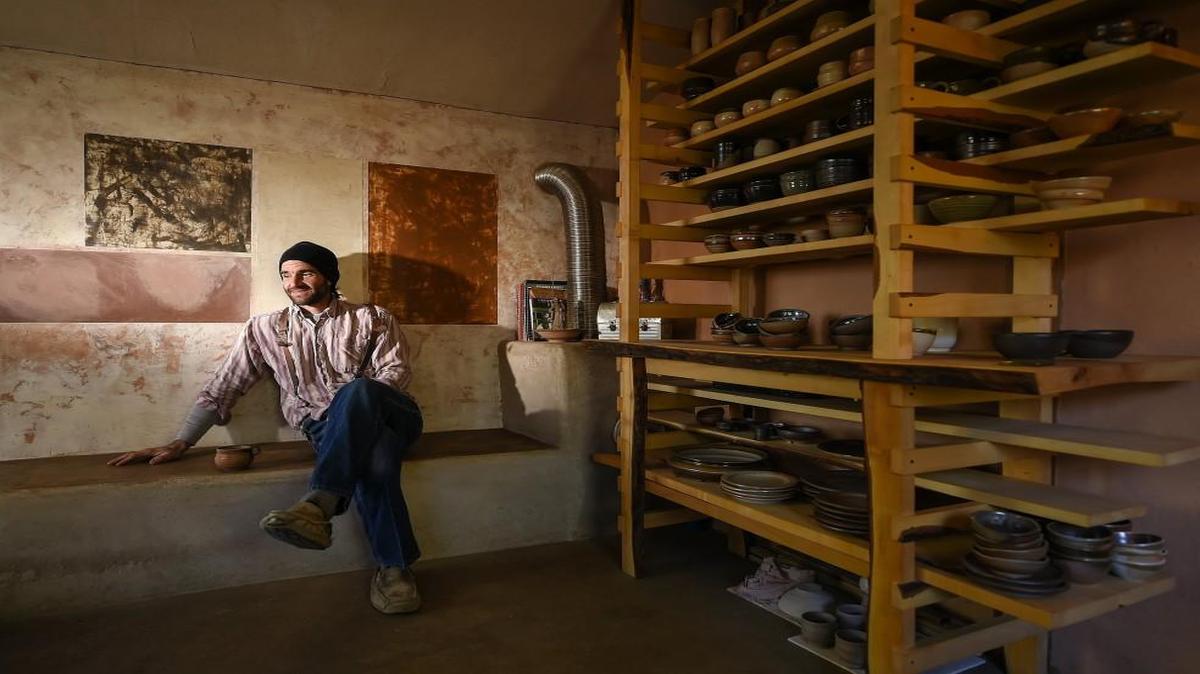 Michael Crouch of Lawrence crafts handmade pottery in his wood-fueled kiln, making stoneware plates for clients like Hank Charcuterie, a Lawrence restaurant. Here he is in his backyard studio.