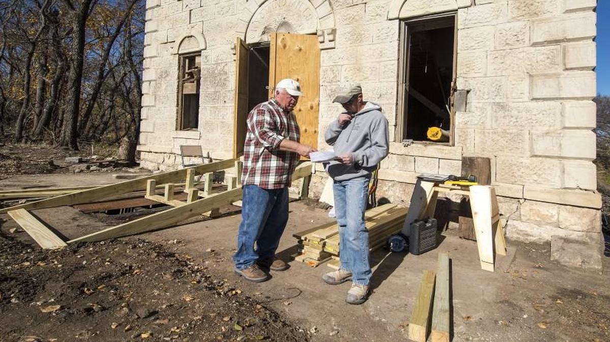 Dan Clothier, a Kansas City developer (left) is working with stone mason Lucas Koch on the restoration of an 1875 grain mill in Cedar Point, Kan., in Chase County.