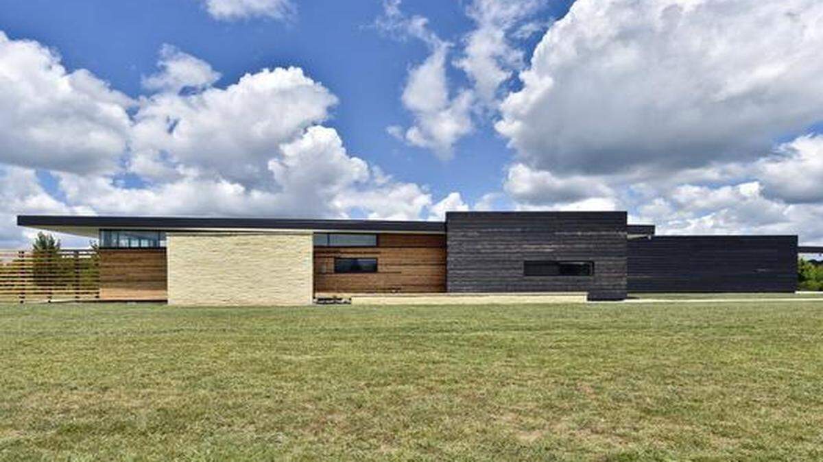 Sharon and David Byers worked with the El Dorado architectural firm to create a low-slung ranch home that allows them to watch the sun set and storms roll in across the plains. Motorists often stop and ask about the home, set on four acres in Lee’s Summit, Sharon Byers says.<252><137>The Byers modern ranch home pictured on Monday, July 28, in Lee's Summit. The Byers, with the help of El Dorado Design, designed this ultra-modern, low-lying ranch house.<252><137>