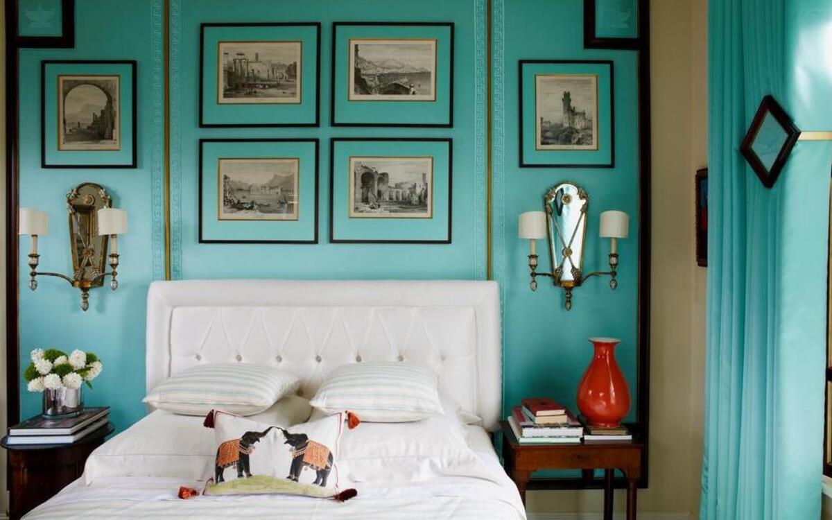 
For the master bedroom, Katillac was inspired by Italy but seen through a 1950s or ’60s lens. Wood Wallcovering Inc. of Lee’s Summit upholstered the walls in aqua fabric, fitting together the wood framing like an intricate puzzle. The white headboard and linens keep the room fresh and modern. 
