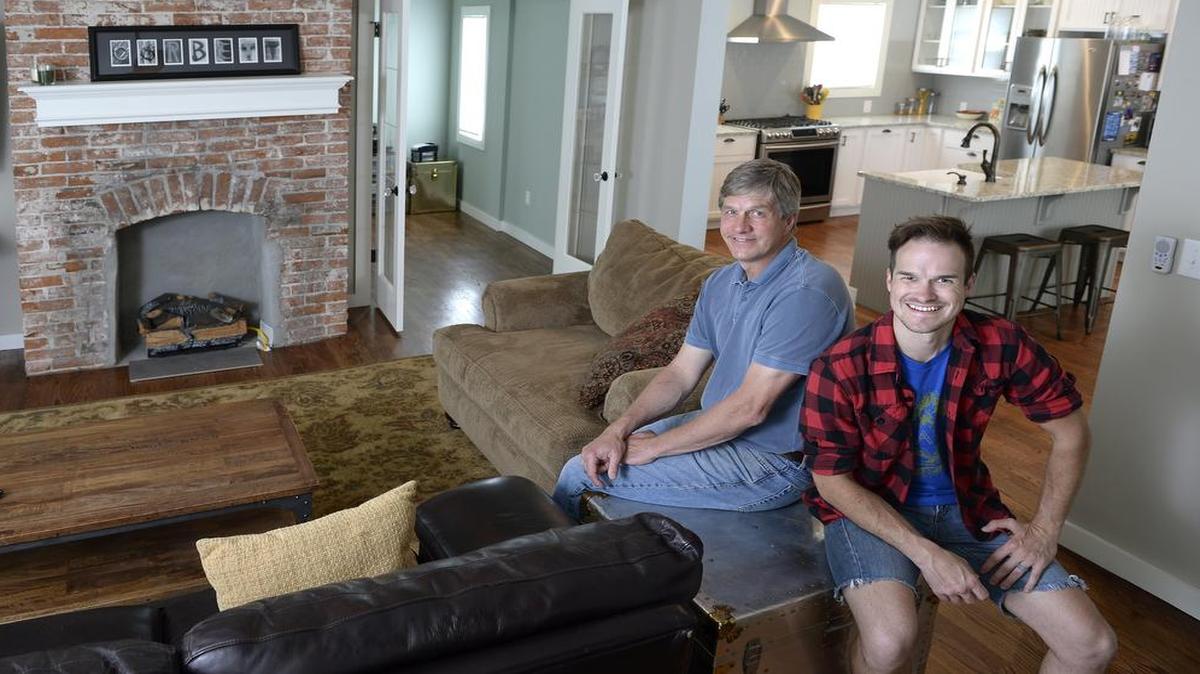 
Ken Personett (left) and his son Kenny rehabbed this 1890s Victorian home in south Hyde Park for Ken’s daughter. The Personetts kept the original brick fireplace in the living room, as well as another in the master bedroom.
