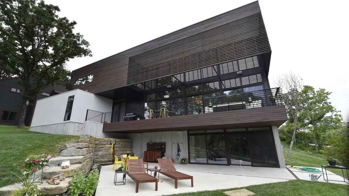 The Walsh’s home looms over their boat dock. “When you are on the water at night and look back, you can see the lights in the house and it’s very warm and pretty,” Austin said. “I’m sure KEM thought of that. It stands out of the trees and lends itself to that modern lodge feel.”