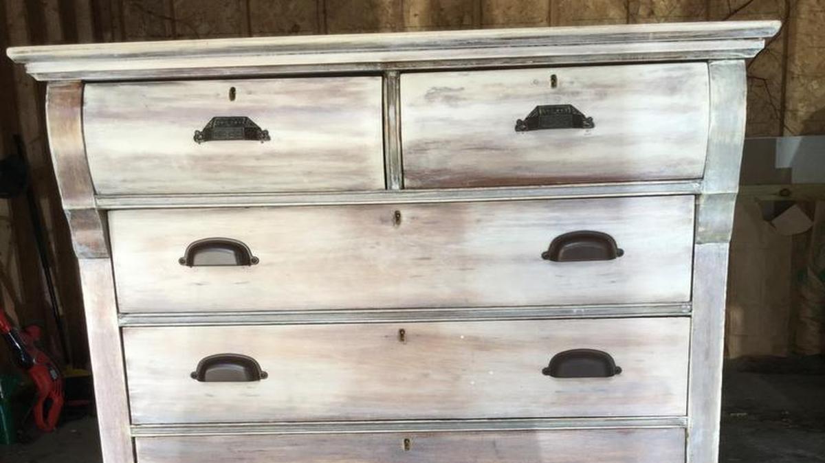A thrift-store dresser after being sanded, whitewashed and coated in polycrylic. The top two pulls are vintage hardware.