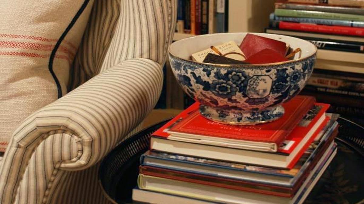 China boxes on top of stacks of books are perfect hiding places for things like reading glasses.