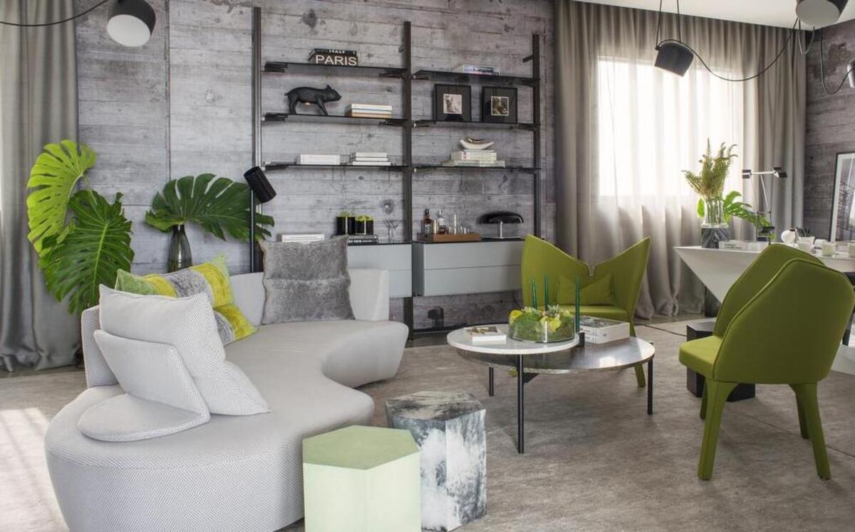 A pair of hexagonal tables from Robicara, one in a shagreen finish and the other with a mottled painted look, are part of a palette punched up by greens.