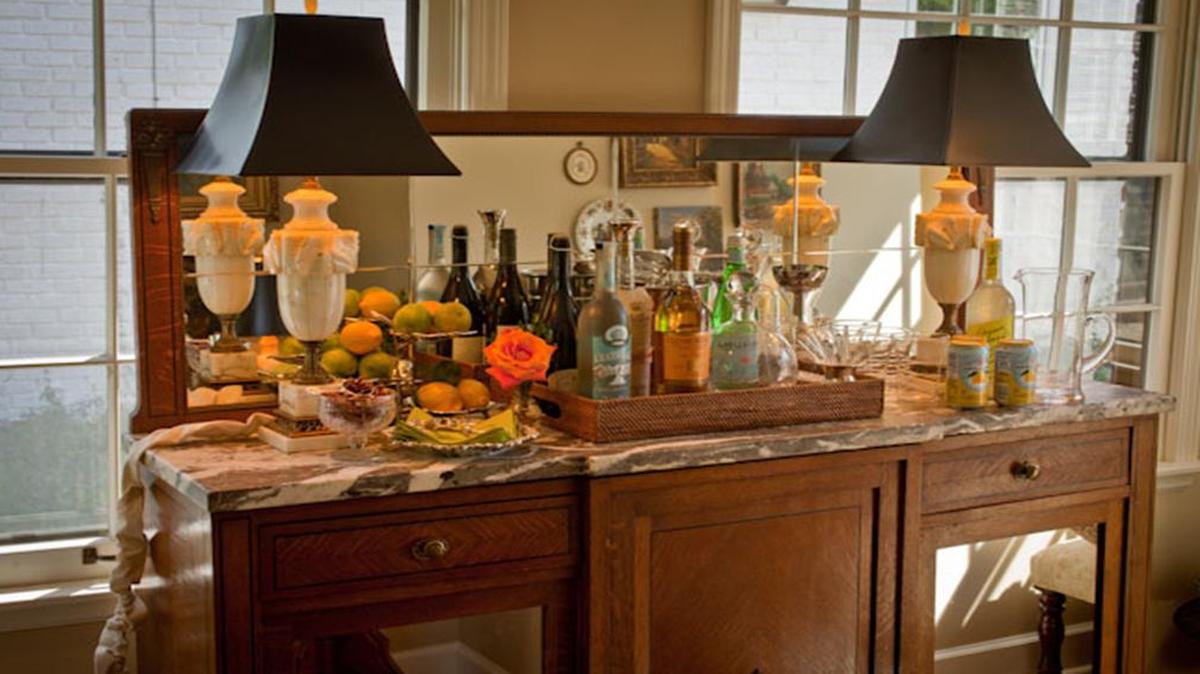 My friend turned her little-used sun porch into a drinks station, with the help of an antique sideboard
