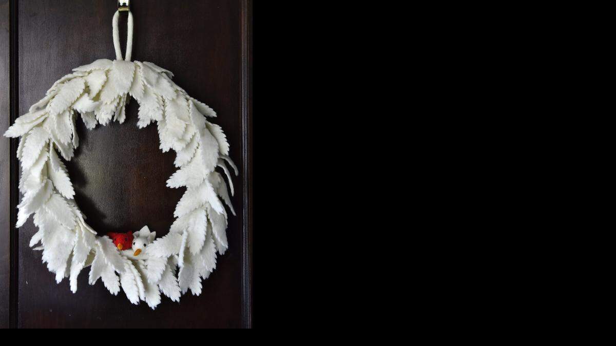 <z_sym_arrow_left> West Elm’s felt wreath ($59) was created by the same fair-trade business in Katmandu, Nepal, that made the garlands and mistletoe.