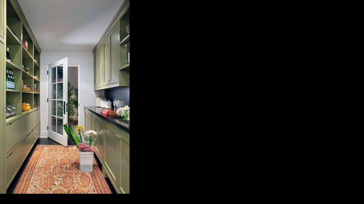 Painting walls and cabinets is a quick and inexpensive way to freshen up a kitchen. Choose colors that you’ll be happy over the long haul rather than something trendy.<252><137>Burnham Design redid this prep kitchen in a Beverly Hills home by painting the cabinets Sherwin Williams “Olive Grove” satin finish and installing a textured black stone countertop.<137><137><252><137>