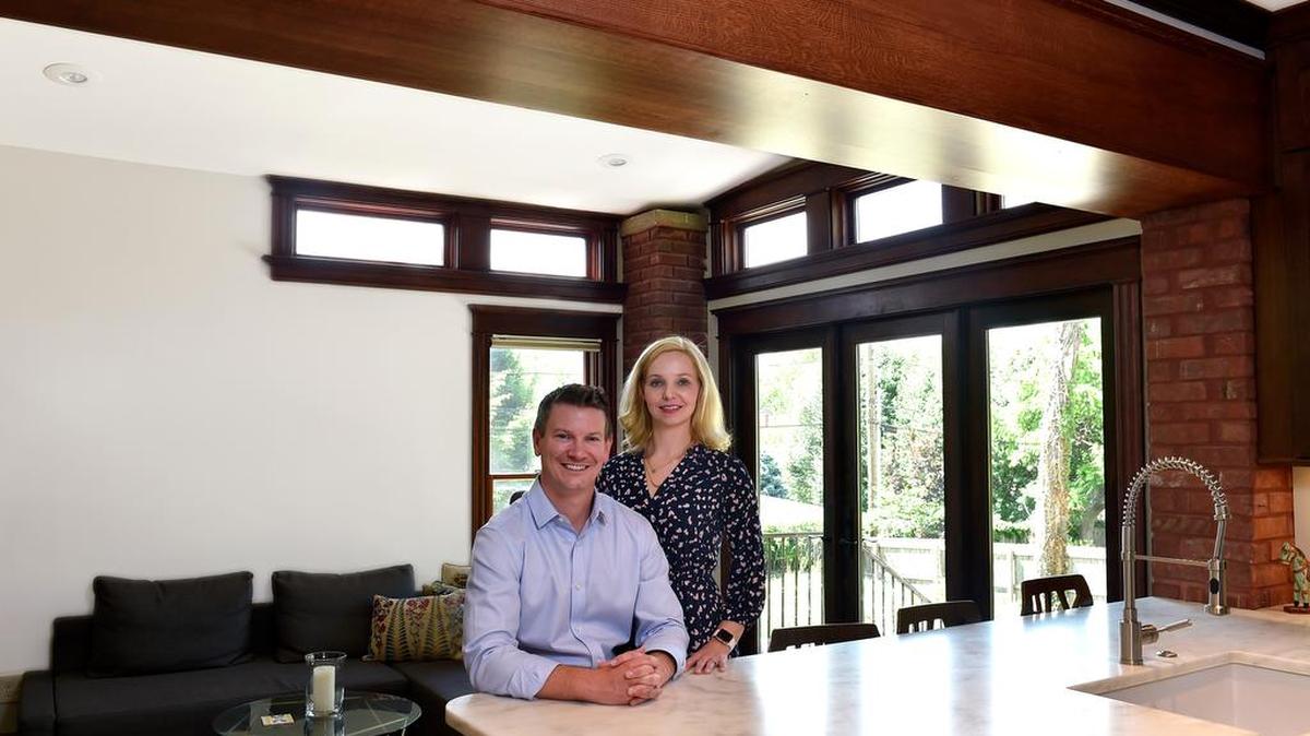 To expand the kitchen and family room in Jeff and Trina LeRiche’s historic home, contractors removed a brick wall and installed a double I-beam and encased it with wood to match the dark natural trim and moldings original to the home. They also raised the sunken family room floor and replaced windows with double-wide patio doors.