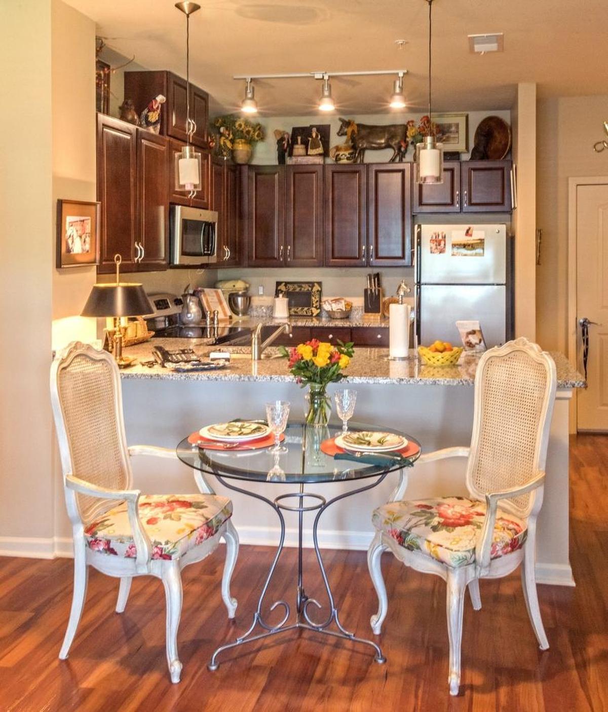View showing petite dining table and compact kithcen.