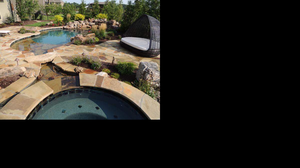 
Linda and DeWayne Bridges, of Overland Park, wanted an outdoor oasis with water falls, firebowls and pool that looks like a lagoon.
