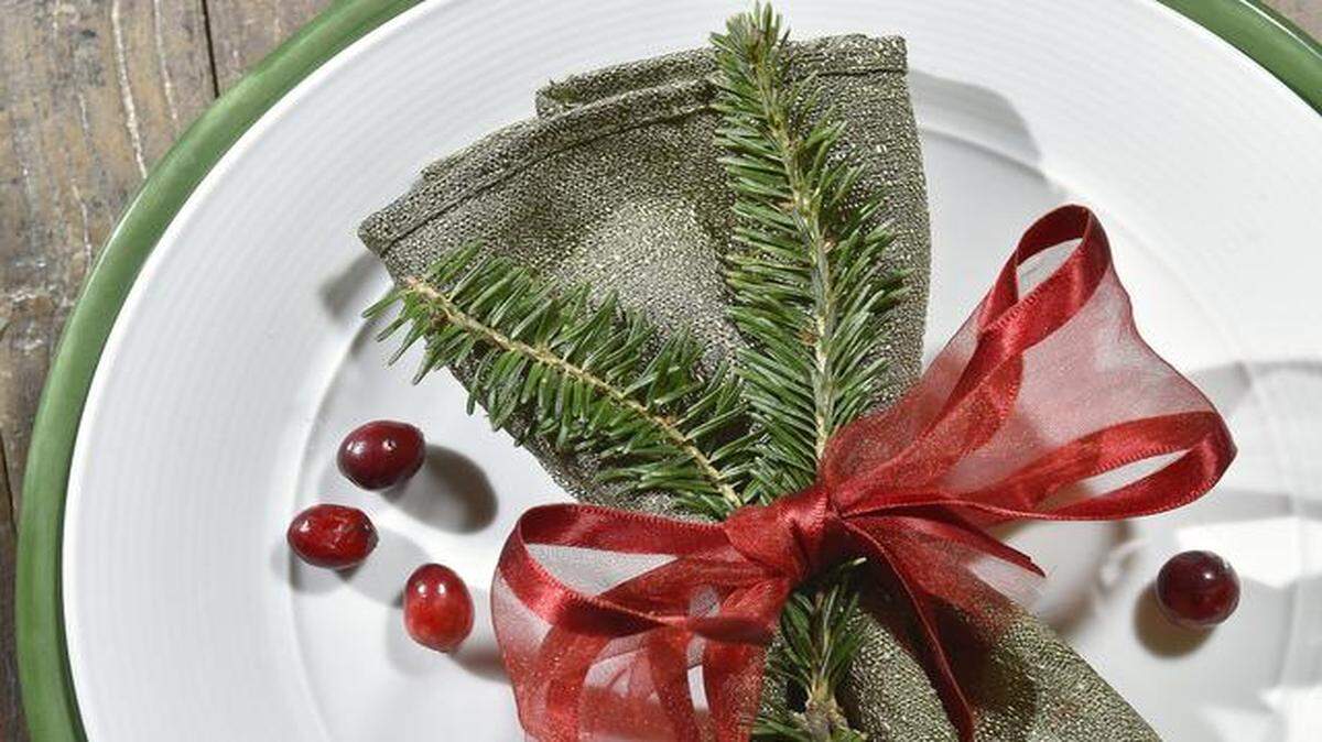 
Tuck sprigs into napkins.
