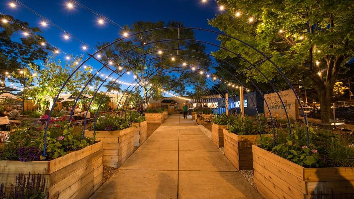 At night, strings of bistro lights twinkle overhead in the pop-up garden at uCity Square in Philadelphia. Low-tech materials keep the mood relaxed and the costs down.