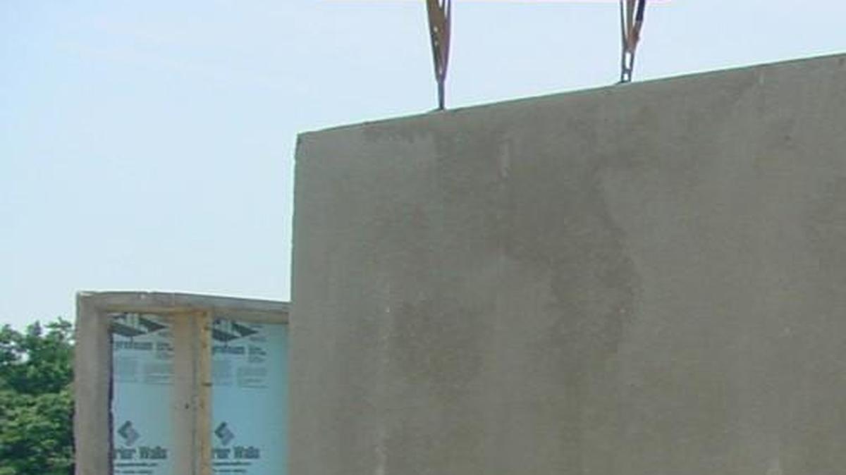 Concrete wall panels are fabricated to architectural plans in factory-controlled conditions and assembled on-site to tight tolerances.