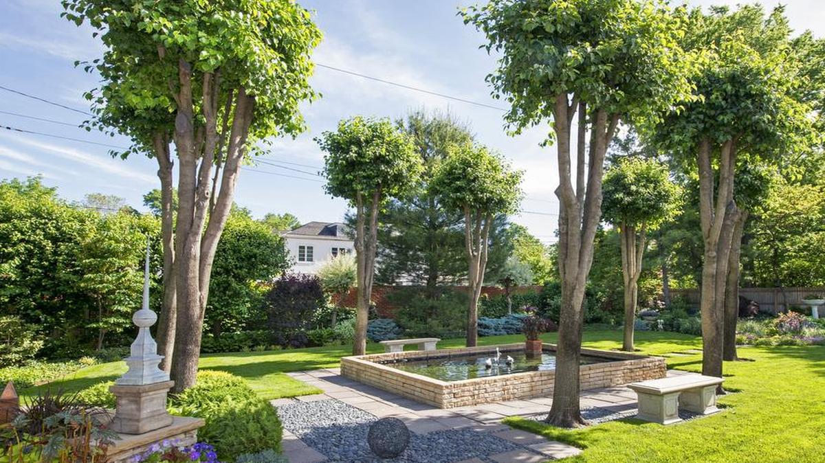 
Jacques Bredius and Danny Bowman’s Kansas City garden includes a water feature framed by creatively topped Bradford pear trees. “When they get too tall, they split, so we keep them like poodles,” Bredius says. Their garden is one of six on the Beautiful Gardens of Kansas City tour June 5-6 
