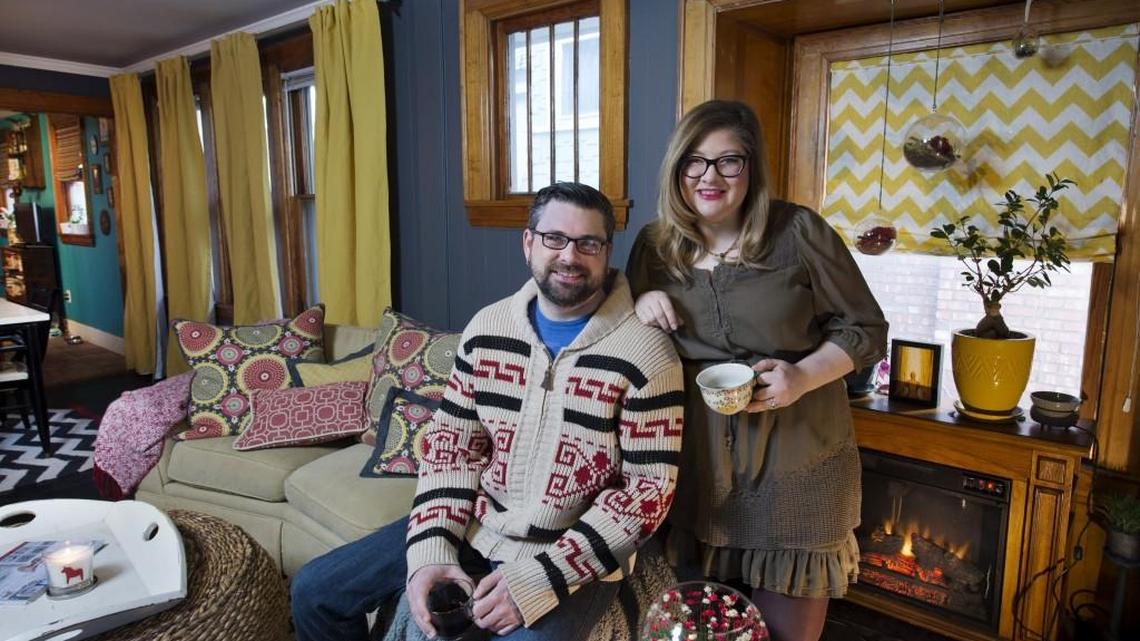 Josh Rogers and Katee McLean, co-owners of Krokstrom Klubb & Market, a midtown restaurant that specializes in Scandinavian food, say hygge describes ways of staying happy and warm during the winter. Their inviting living room and his “Big Lebowski” sweater are very hygge.