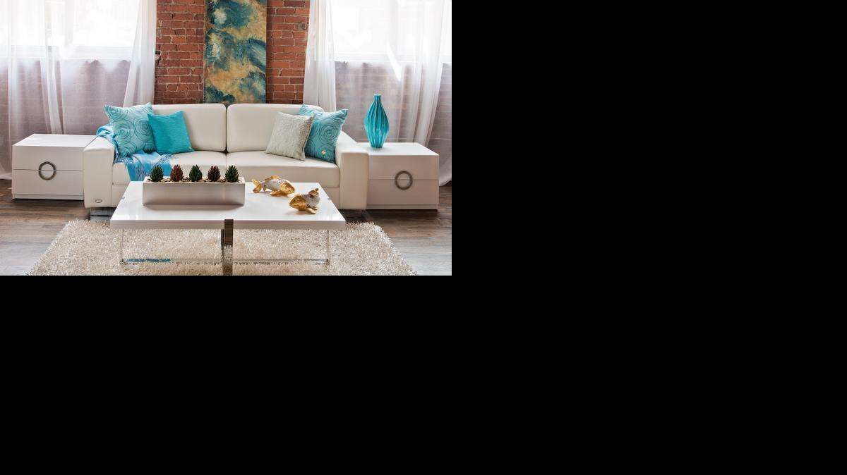 
Pillows and a cashmere throw in shades of aqua blue, all from Alejandro Home Design, create a tranquil feel. Turquoise Swirl pillows ($160 each) flank a Pale Blue Strings pillow ($175, on the right), and a turquoise City Pillow, ($155). 
